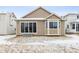 View of the backyard featuring a large sliding glass door and a bay window at 9673 Ceylon St, Commerce City, CO 80022