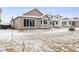 Spacious backyard featuring a large sliding glass door and bay windows at 9673 Ceylon St, Commerce City, CO 80022