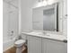 Clean bathroom featuring white tile, a single sink, and tub with shower at 9673 Ceylon St, Commerce City, CO 80022