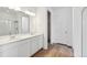 Bright bathroom featuring double sinks, modern lighting, and a glass shower at 9673 Ceylon St, Commerce City, CO 80022
