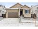 Charming single-Gathering home featuring a stone-accented facade and attached two-car garage at 9673 Ceylon St, Commerce City, CO 80022