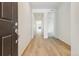 Bright hallway featuring wood floors and white walls at 9673 Ceylon St, Commerce City, CO 80022