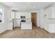 Modern kitchen featuring stainless steel appliances, wood floors, and white cabinets at 9673 Ceylon St, Commerce City, CO 80022