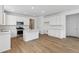 Modern kitchen featuring stainless steel appliances, wood floors, and white cabinets at 9673 Ceylon St, Commerce City, CO 80022