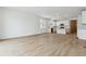Bright open-concept living space featuring wood floors, stainless steel appliances, and white walls at 9673 Ceylon St, Commerce City, CO 80022