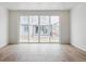 Light-filled living room showcasing wood floors and a large sliding glass door at 9673 Ceylon St, Commerce City, CO 80022