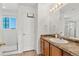 Bright bathroom featuring a shower over tub and a vanity with oak cabinets and a modern mirror at 3026 S Waco Ct, Aurora, CO 80013