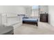 Cozy bedroom with neutral carpet features a crib and dark dresser near a bright window at 3026 S Waco Ct, Aurora, CO 80013