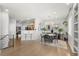 Open concept dining area with modern chandelier, decor, and views into the living room at 3026 S Waco Ct, Aurora, CO 80013