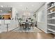 Bright dining room featuring a modern chandelier, open layout and views into the kitchen at 3026 S Waco Ct, Aurora, CO 80013