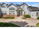 Charming two-story townhouse featuring a covered entryway, well-maintained landscaping and brick accents at 3026 S Waco Ct, Aurora, CO 80013