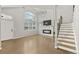 Bright living room with tall ceilings, large windows, modern fireplace, and staircase at 3026 S Waco Ct, Aurora, CO 80013