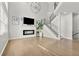 Spacious living room featuring a modern fireplace, wood floors and open staircase at 3026 S Waco Ct, Aurora, CO 80013