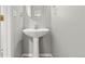 Simple powder room featuring a pedestal sink, neutral color and great natural light at 3026 S Waco Ct, Aurora, CO 80013