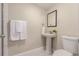 Cozy powder room features a pedestal sink, updated flooring, and tile accents at 10370 Routt St, Westminster, CO 80021