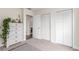 Bedroom featuring a bright closet space and views to an ensuite bathroom at 10370 Routt St, Westminster, CO 80021