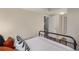 Cozy bedroom with stylish bedding, hardwood floors, and an open doorway at 10370 Routt St, Westminster, CO 80021