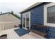Inviting deck featuring bench seating, sliding door, and dark blue siding at 10370 Routt St, Westminster, CO 80021