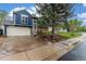 Charming two-story home featuring a spacious driveway and a beautiful mature tree in the front yard at 10370 Routt St, Westminster, CO 80021