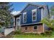 Two-story home with blue siding, brick accents, well-manicured lawn, and a welcoming front entrance at 10370 Routt St, Westminster, CO 80021