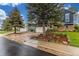 Charming two-story home with well-manicured lawn, driveway, and lush landscaping with mature trees at 10370 Routt St, Westminster, CO 80021