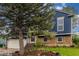 Exterior view of house with large tree and brick accents at 10370 Routt St, Westminster, CO 80021