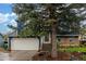 Front exterior view with large tree partially obstructing house at 10370 Routt St, Westminster, CO 80021