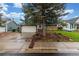 Charming front exterior view with large tree and driveway at 10370 Routt St, Westminster, CO 80021
