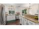 Kitchen area featuring stainless appliances, granite counters, and white cabinets at 10370 Routt St, Westminster, CO 80021