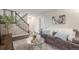 Comfortable living room with plush seating, elegant decor, and staircase leading to upper level at 10370 Routt St, Westminster, CO 80021
