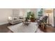 Bright living room with large windows, comfortable seating and modern decor creates an inviting atmosphere at 10370 Routt St, Westminster, CO 80021