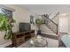 Bright living room featuring a stylish TV console, adjacent to a staircase, creating a welcoming space at 10370 Routt St, Westminster, CO 80021