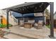 Covered patio featuring stylish seating, a dark pergola and blue siding at 10370 Routt St, Westminster, CO 80021