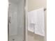 Bright, remodeled tiled shower stall with seamless glass door at 10370 Routt St, Westminster, CO 80021