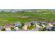 An elevated angle of properties backing up to an open field with distant lake views at 15779 W 83Rd Pl, Arvada, CO 80007