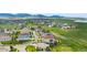 An aerial view of a neighborhood showcasing a residential area with green spaces and mountain views at 15779 W 83Rd Pl, Arvada, CO 80007