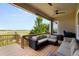 Covered outdoor living space features comfortable seating and peaceful views at 15779 W 83Rd Pl, Arvada, CO 80007