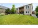 Spacious backyard features mature trees, lush lawn, and a two story deck at 15779 W 83Rd Pl, Arvada, CO 80007