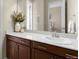 Bathroom featuring granite countertop, wood cabinets, and decor at 15779 W 83Rd Pl, Arvada, CO 80007