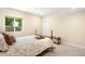 Cozy bedroom features a window offering natural light, with neutral walls and carpeting at 15779 W 83Rd Pl, Arvada, CO 80007