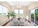 Bright dining room features a wooden table set, natural light, and sliding glass doors to the patio at 15779 W 83Rd Pl, Arvada, CO 80007