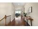 Welcoming entryway with hardwood floors and a view into the living room featuring natural light at 15779 W 83Rd Pl, Arvada, CO 80007