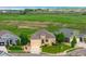 Exterior shot of a tan home with a well-manicured lawn at 15779 W 83Rd Pl, Arvada, CO 80007