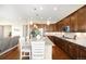 Spacious kitchen with granite countertops, stainless appliances, a large island, and hardwood floors at 15779 W 83Rd Pl, Arvada, CO 80007