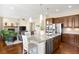 Open concept kitchen featuring stainless appliances, a granite island, and hardwood floors at 15779 W 83Rd Pl, Arvada, CO 80007