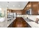 Modern kitchen featuring granite counters, stainless appliances, and wood cabinets at 15779 W 83Rd Pl, Arvada, CO 80007