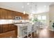 Modern kitchen with a large island, stainless steel appliances, and stylish pendant lighting at 15779 W 83Rd Pl, Arvada, CO 80007