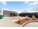 Enjoy the backyard featuring a greenhouse and landscaping with rock accents and a paved patio at 4849 N Cook St, Denver, CO 80216