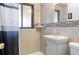 Cozy bathroom featuring tiled walls, modern fixtures, and a shower with a patterned curtain at 4849 N Cook St, Denver, CO 80216