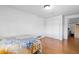 Bedroom featuring hardwood floors, a closet, and natural light from the window at 4849 N Cook St, Denver, CO 80216